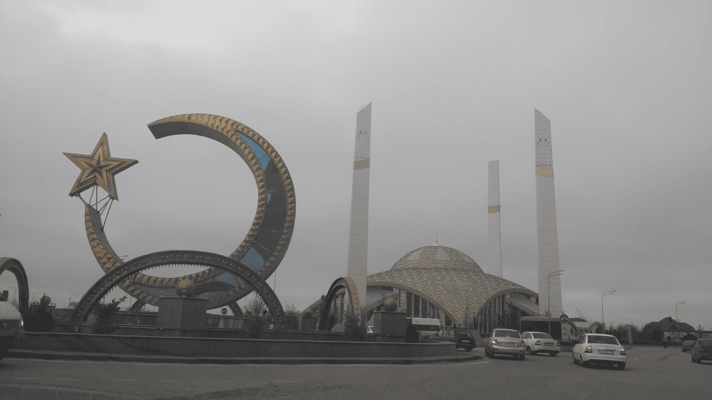 Argun Mosque with modern dome and tall minarets under cloudy sky in Chechnya