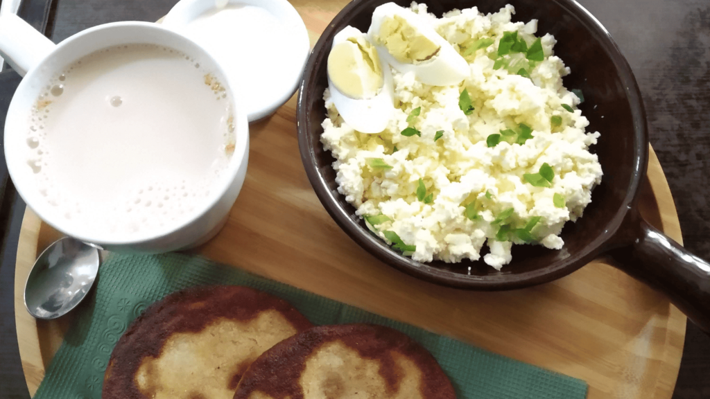 Traditional Chechen breakfast with corn flatbread siskal and milk tea