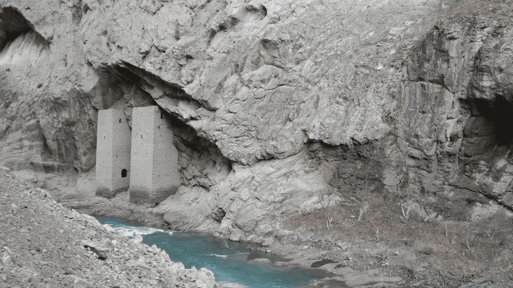 Medieval Ushkaloi towers built into a cliff above the Argun River in Chechnya