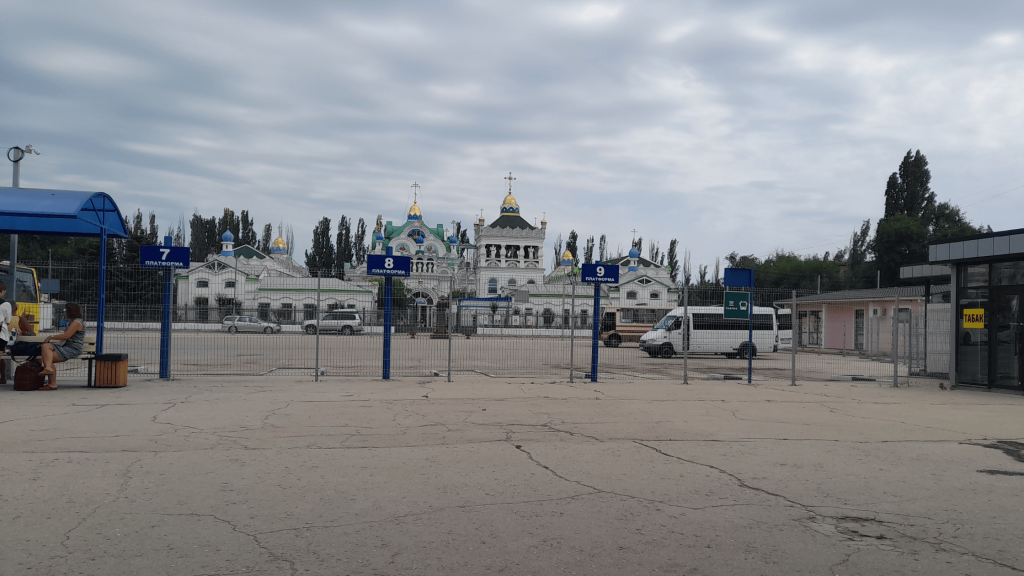 Bus station in Feodosia with golden-domed Orthodox church behind