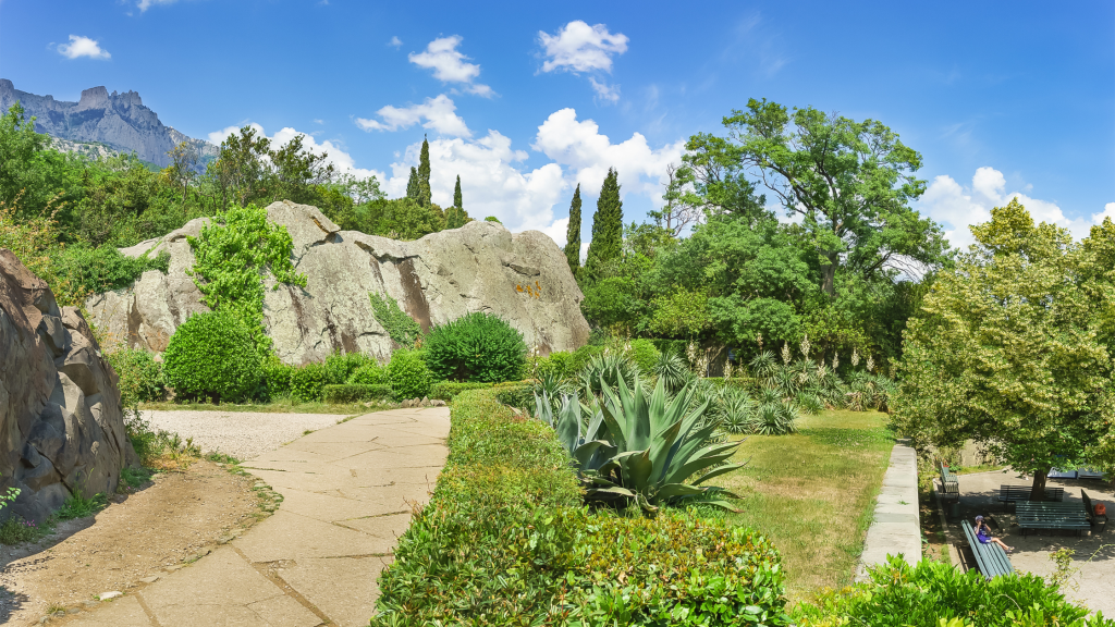 Landscape garden of Vorontsov Palace in Alupka with Crimean mountains behind