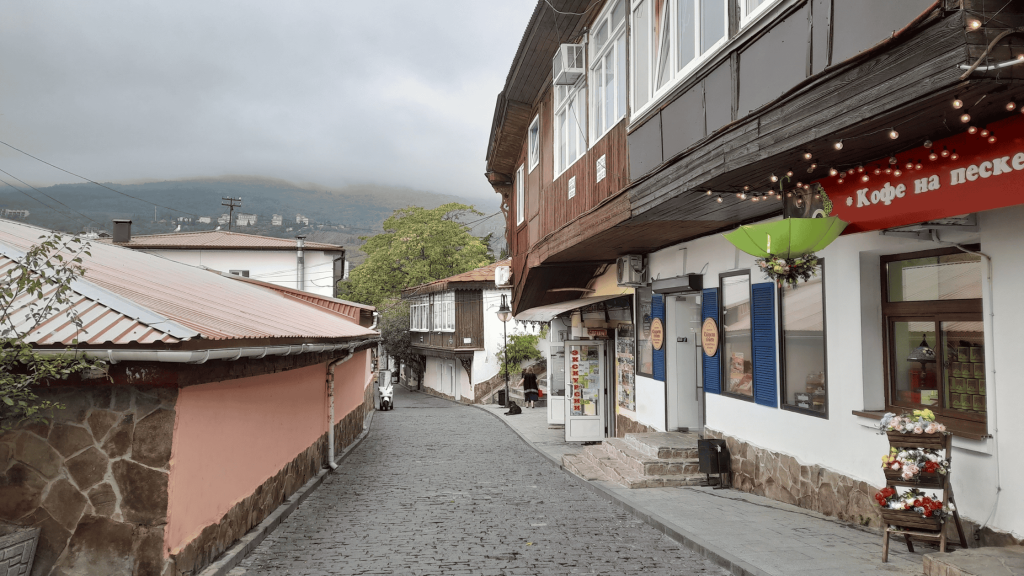 Cobblestone street in Gurzuf old town with traditional wooden houses