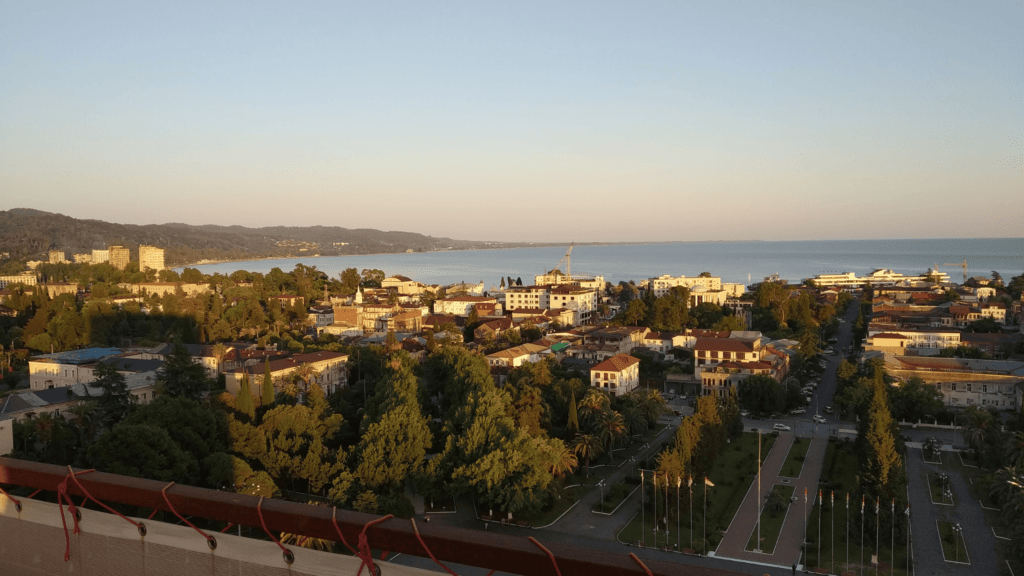 Aerial view of Sukhumi, the capital of Abkhazia, at sunset, with the Black Sea in the background.