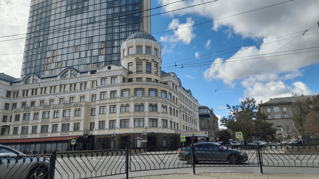 Donbass Palace hotel building in Donetsk under clear blue sky, photographed in 2026.