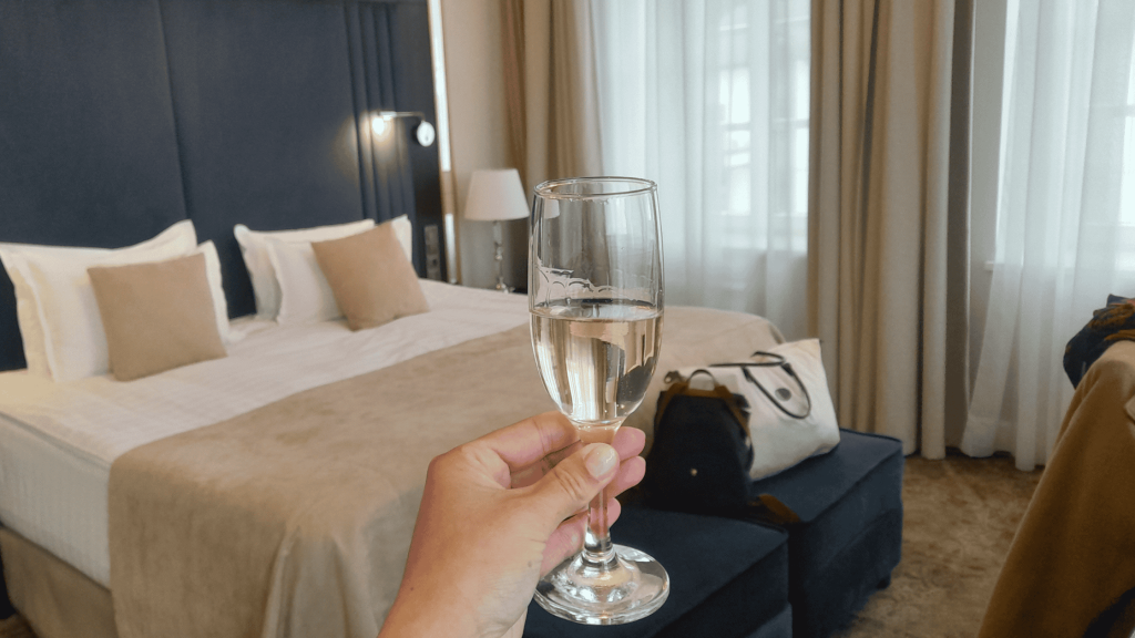 Glass of Chateau Tamagne sparkling wine in a cozy room at Pestrikov Hotel Smolensk