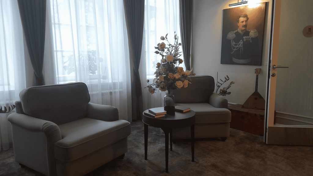 Elegant Pestrikov hotel lounge in Smolensk with armchairs, portrait, and vintage décor
