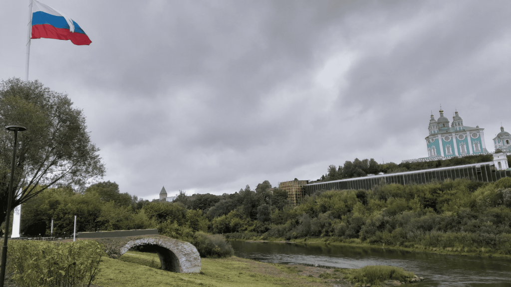 View of the Assumption Cathedral in Smolensk above the Dnieper River with Russian flag