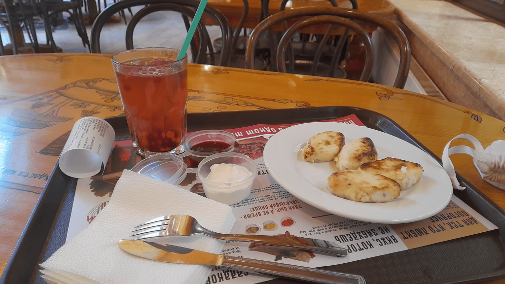 Traditional lapun pancakes and sea buckthorn tea at Russky Dvor Café in Smolensk – local food travel guide
