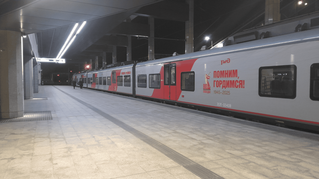 Smolensk–Minsk train at night station platform in Russia – RZD regional train service