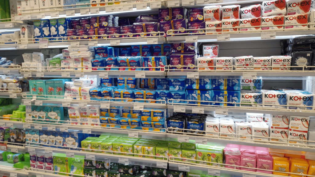 shelves with sanitary pads and tampons in Russian supermarket, period products available for solo female travelers in Russia