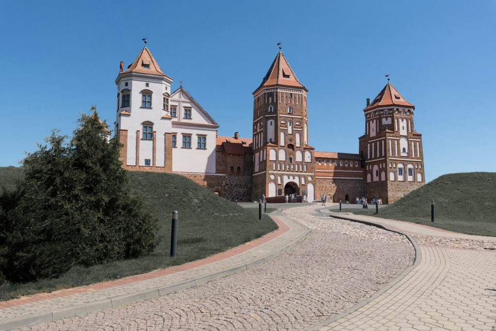 Historic castle with towers on a grassy hill