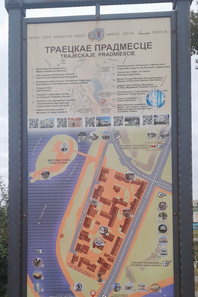 Map sign in Belarusian and English showing Trinity Suburb (Trayeckaje Pradmiescie) and nearby landmarks in Minsk, Belarus.