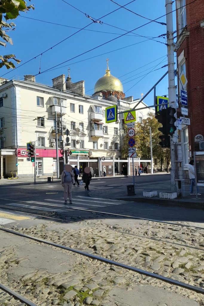 Street with tram tracks and golden dome Orthodox cathedral in Krasnodar Russia
