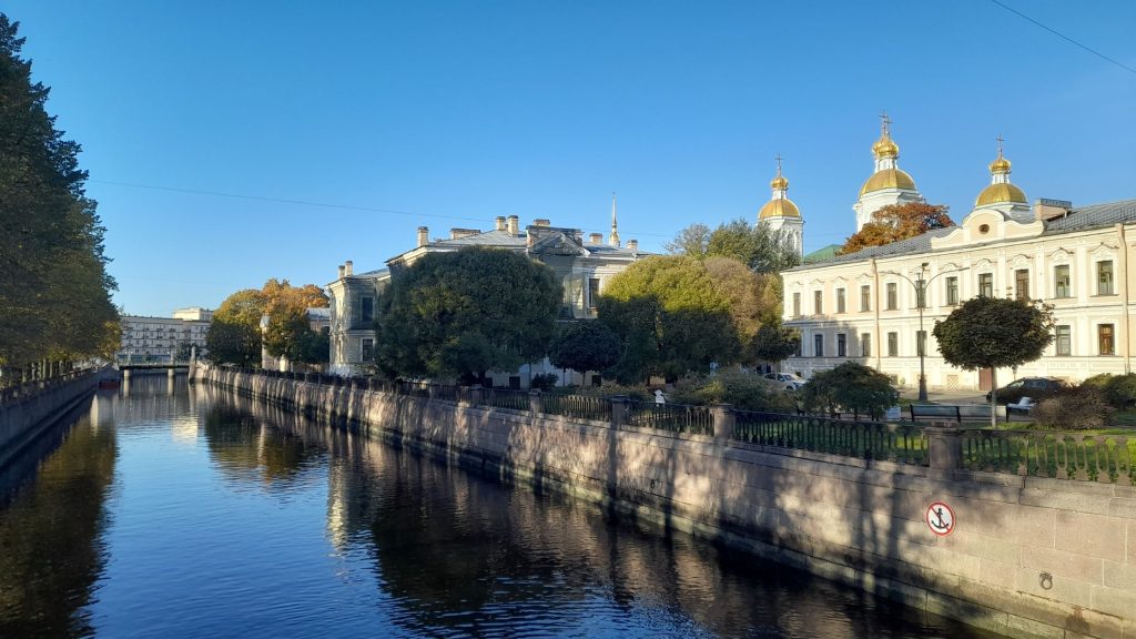 Alexander Nevsky Monastery in Saint Petersburg reflected in the Monastyrka River on a clear sunny day.