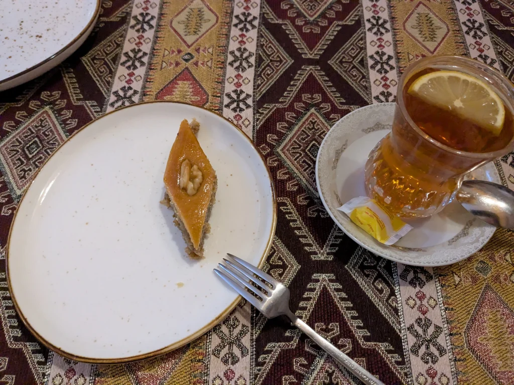 Slice of Azerbaijani baklava with traditional tea at Nergiz Restaurant in Baku