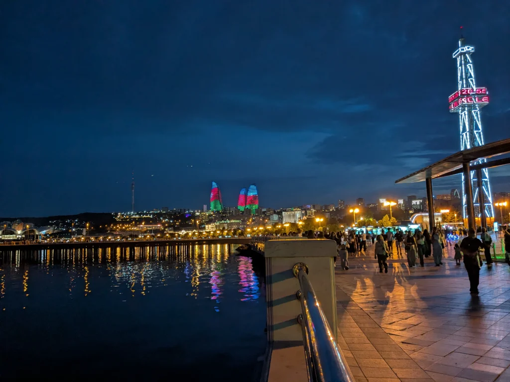 Baku Boulevard illuminated at night with the Flame Towers in the distance