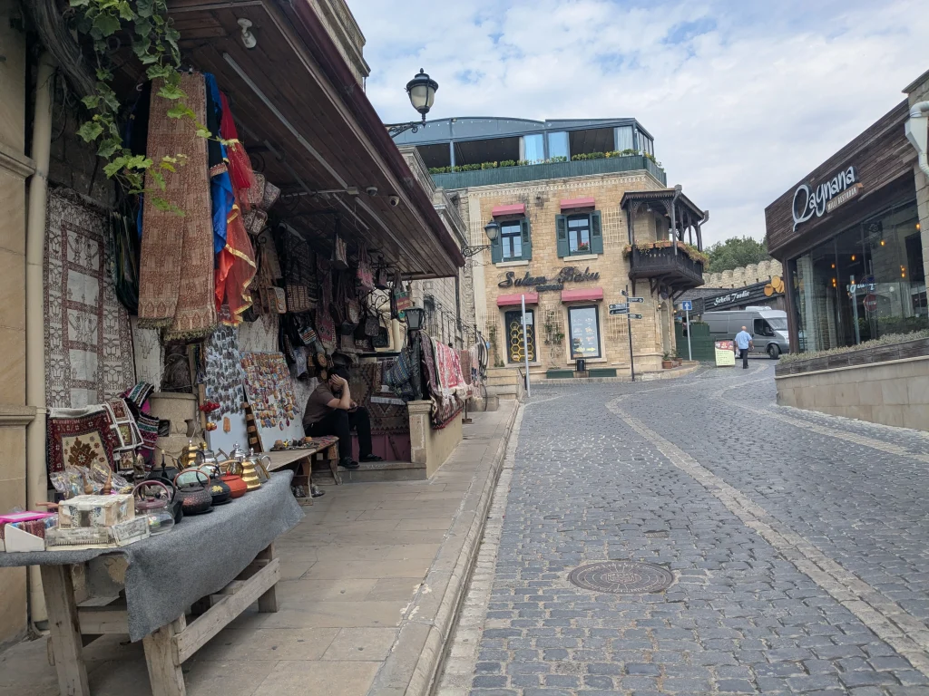 Traditional souvenir stalls along a cobblestone street in Icherisheher