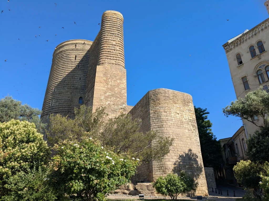 Medieval Maiden Tower surrounded by historic buildings in Baku Old City